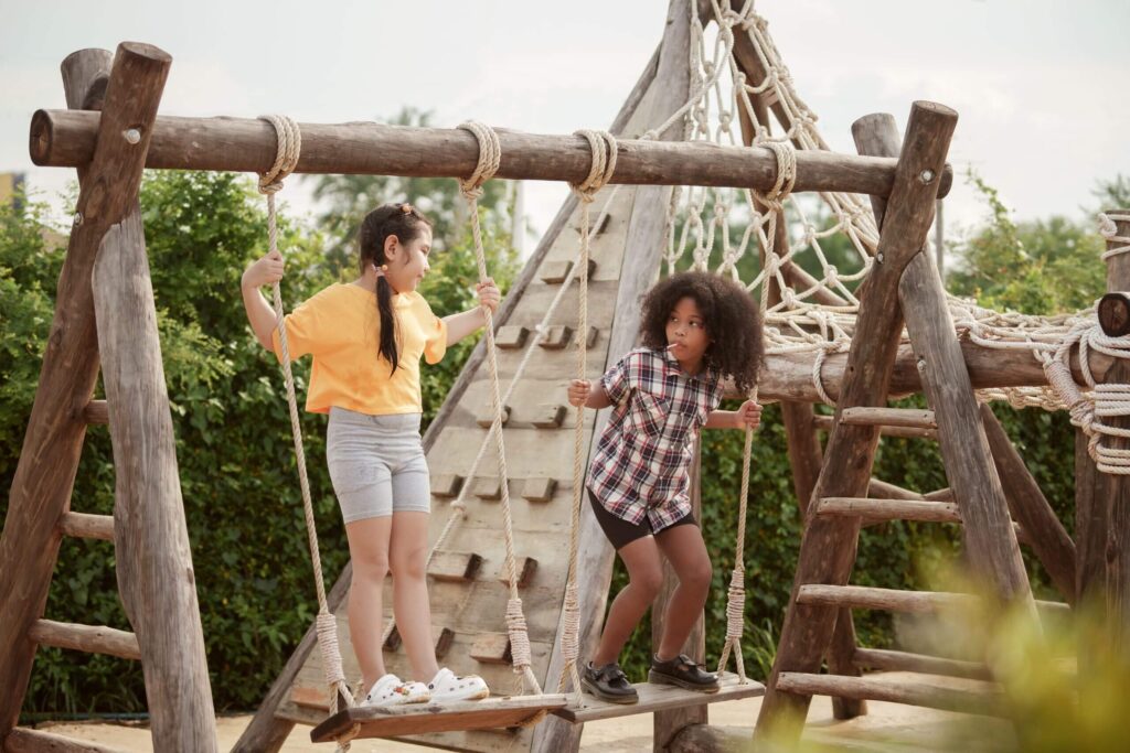 two-kids-girl-are-playing-on-the-swing-in-the-outd-2023-01-18-04-44-06-utc-scaled